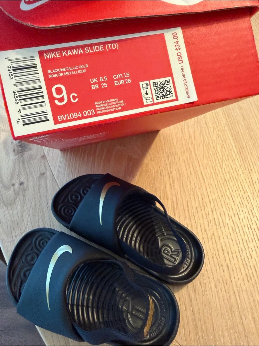 Nike Kids Black Slides with Gold Swoosh and Heel Strap